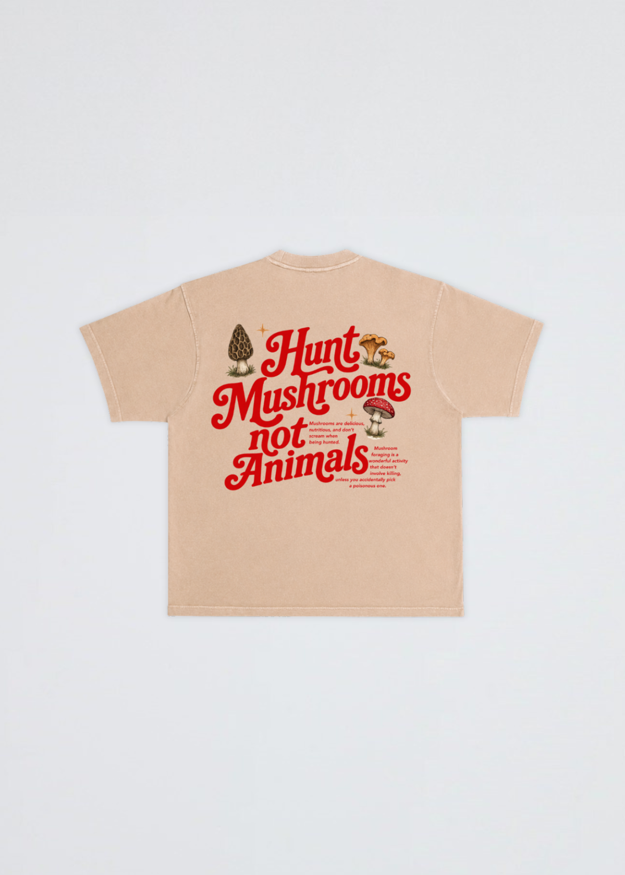 A beige short-sleeve t-shirt shown flat against a light gray background, featuring a graphic on the back with the text 'Hunt Mushrooms not Animals' in red, accompanied by illustrations of a morepenny and mushrooms.